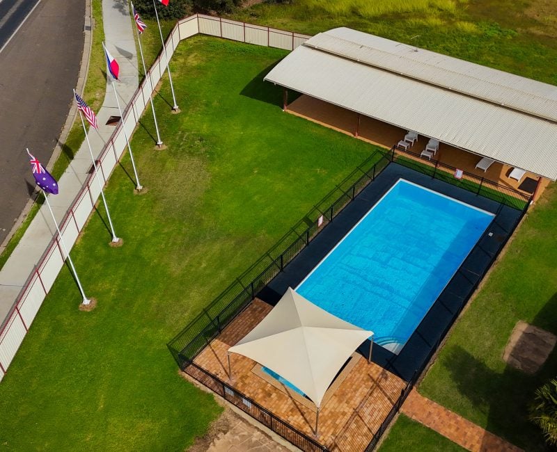 Aerial view of Nandewar Motor Inn's outdoor amenities situated next to a road