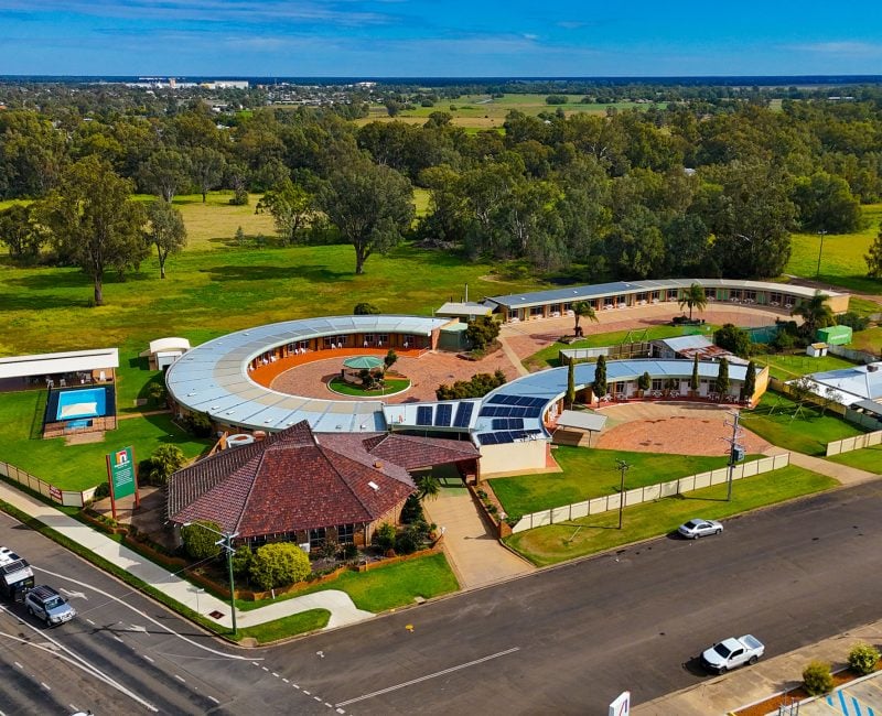 Aerial view of Nandewar Motor Inn situated on the edge of a rural area or small town.
