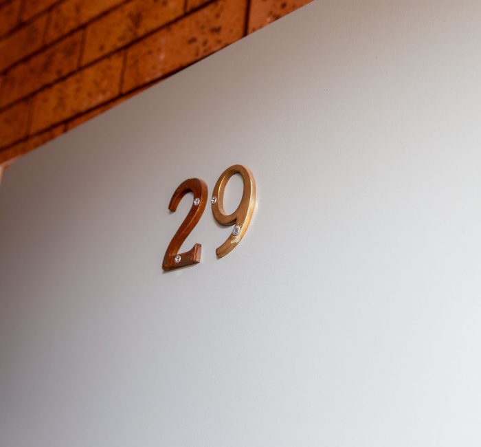 A close-up of a motel room door number.