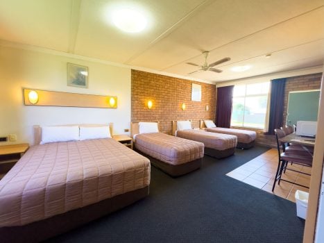 A brightly lit, spacious Nandewar Motor Inn room designed for a family or group.