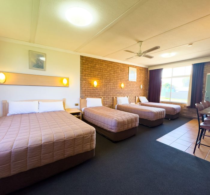 A brightly lit, spacious Nandewar Motor Inn room designed for a family or group.