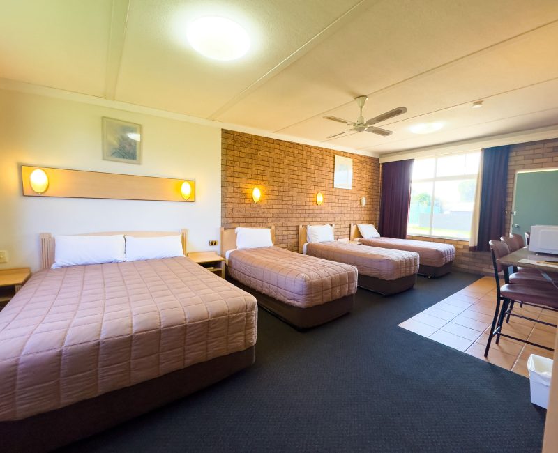 A brightly lit, spacious Nandewar Motor Inn room designed for a family or group.