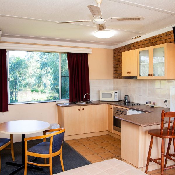 Nandewar Motor Inn room that is fully equipped with a kitchenette and dining area.