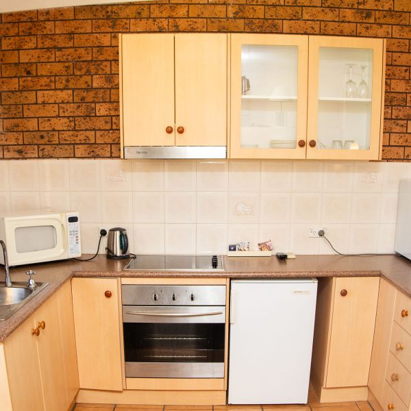 Nandewar Motor Inn room kitchenette that is integrated into the living space.
