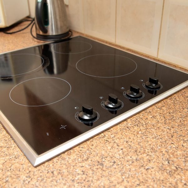 A close-up of a kitchen countertop and stove top.