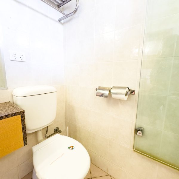A close-up of the toilet and amenities area in Nandewar Motor Inn bathroom.
