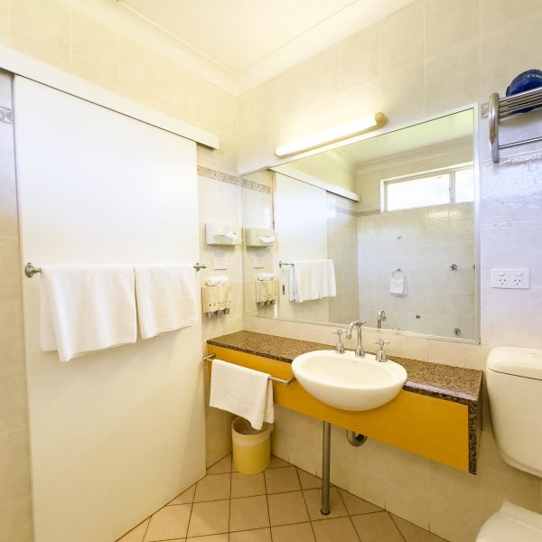 A brightly lit, Nandewar Motor Inn bathroom vanity area.