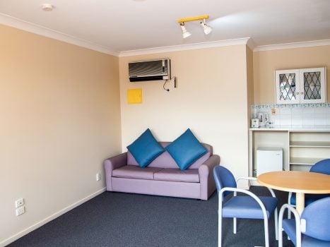 Lounge and kitchenette area of Nandewar Motor Inn's room.