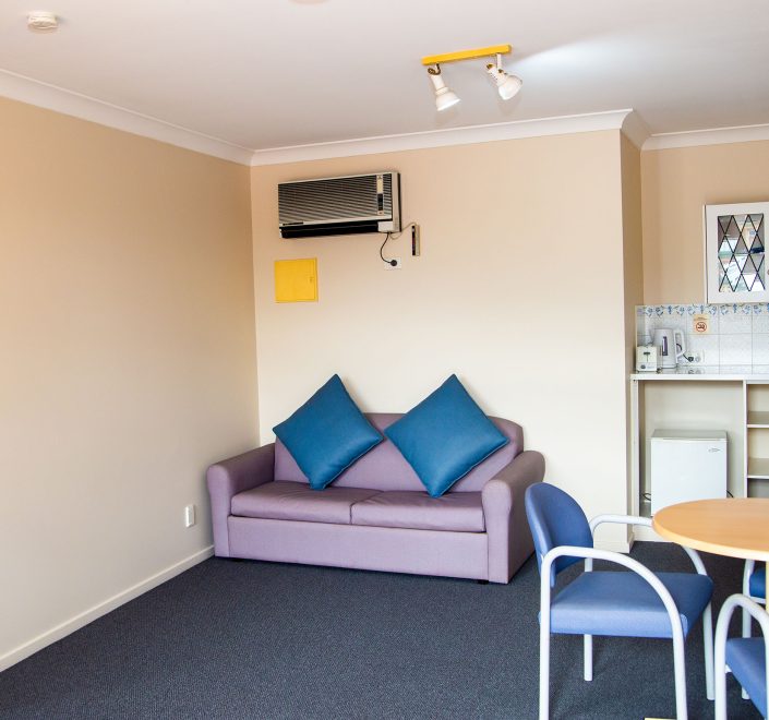 Lounge and kitchenette area of Nandewar Motor Inn's room.