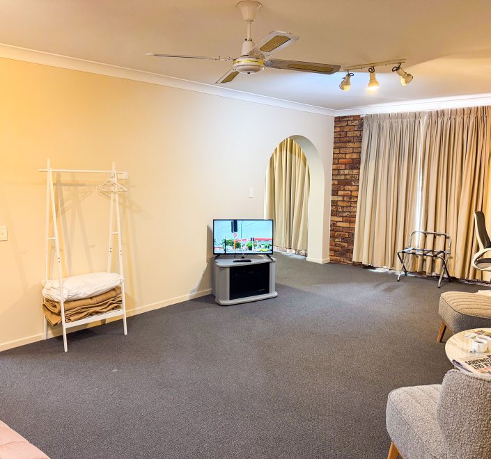 The interior of Nandewar Motor Inn's room, highlighting the living and entertainment spaces.